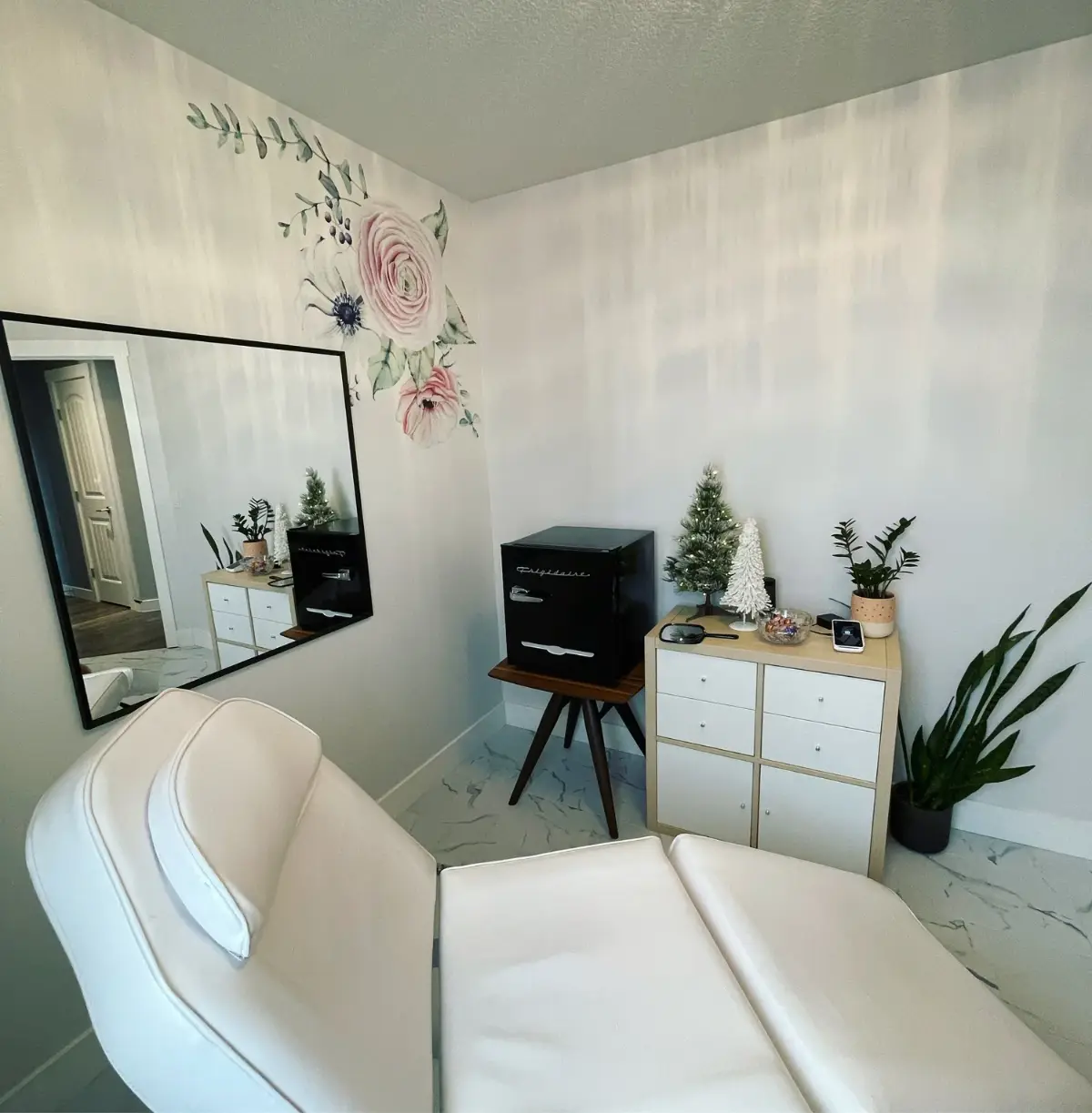 The Wildflower treatment room with floral wall art